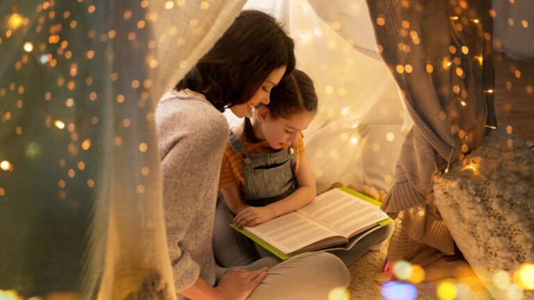 Mother reading with daughter a book
